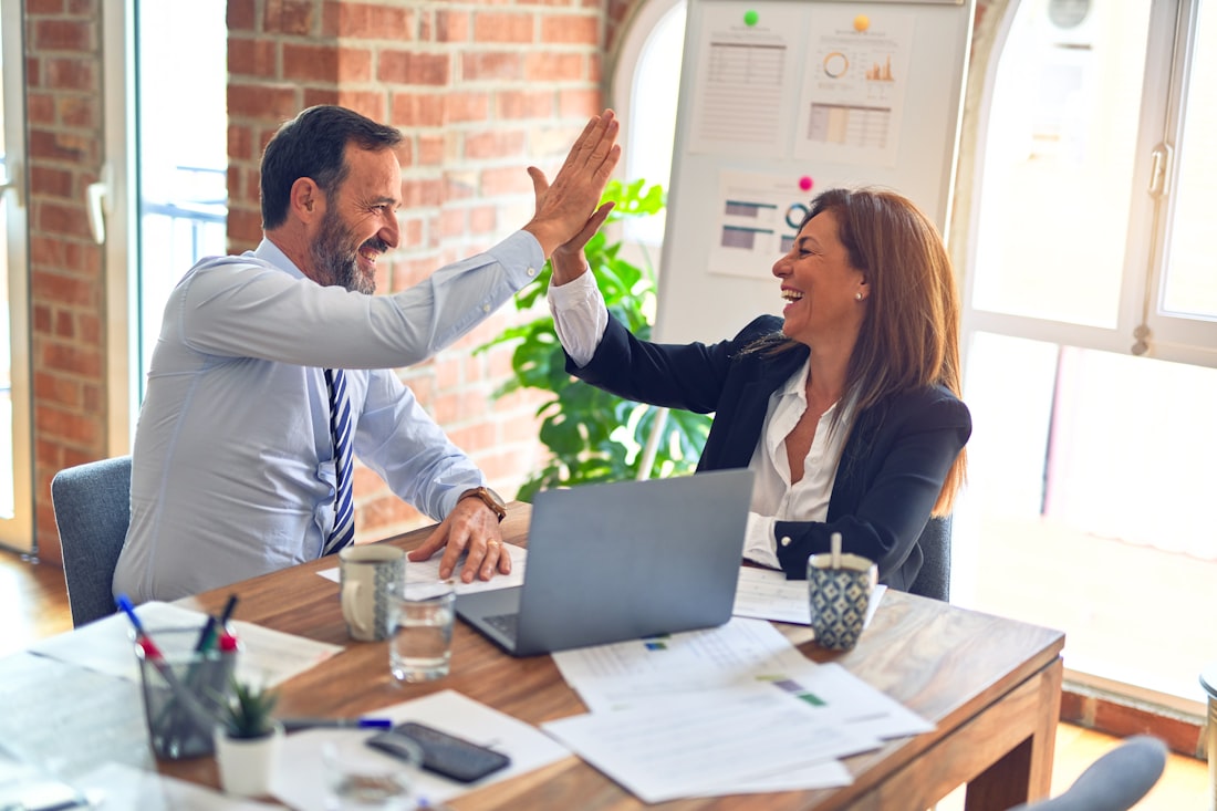 Two people reviewing paperwork together